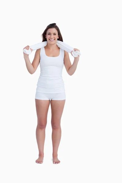 Smiling young woman looking at the camera while holding a towel Royalty Free Stock Images