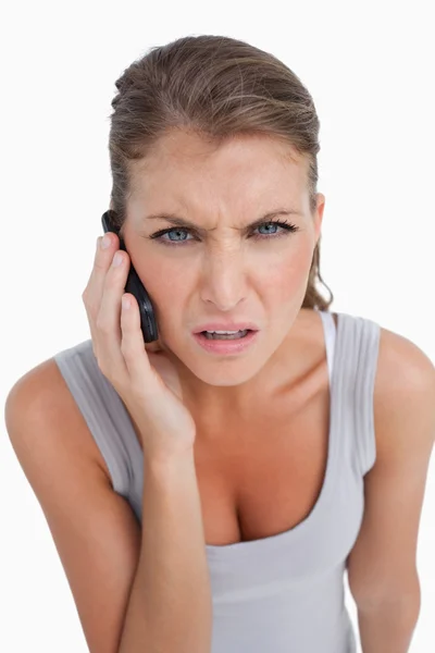 Portrait of a confused woman making a phone call Royalty Free Stock Photos