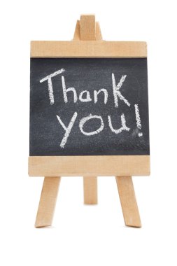 Chalkboard with the words thank you written on it clipart