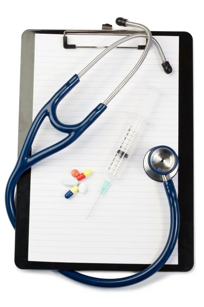 Notizblock mit blauem Stethoskop und Pillen — Stockfoto