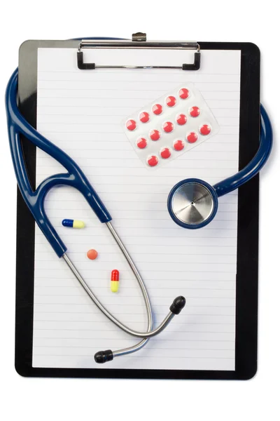 Note pad and stethoscope with color pills and blister strip — Stock Photo, Image