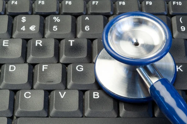 stock image Blue stethoscope on keyboard