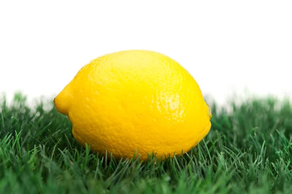 stock image Yellow lemon on grass