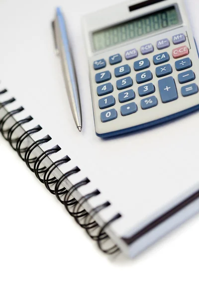 stock image Angled notebook with pencil and pocket calculator