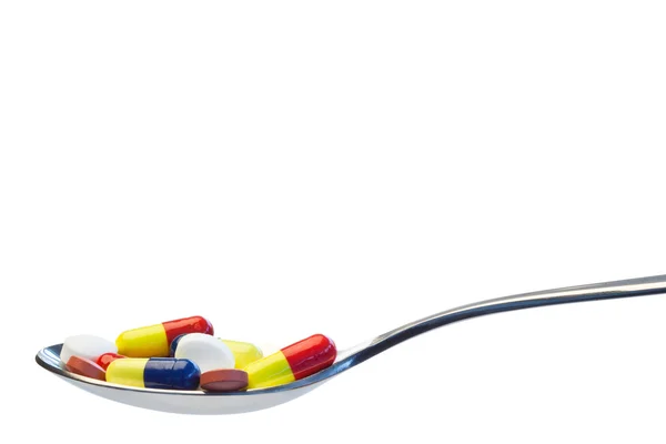 Colher cheia de comprimidos — Fotografia de Stock