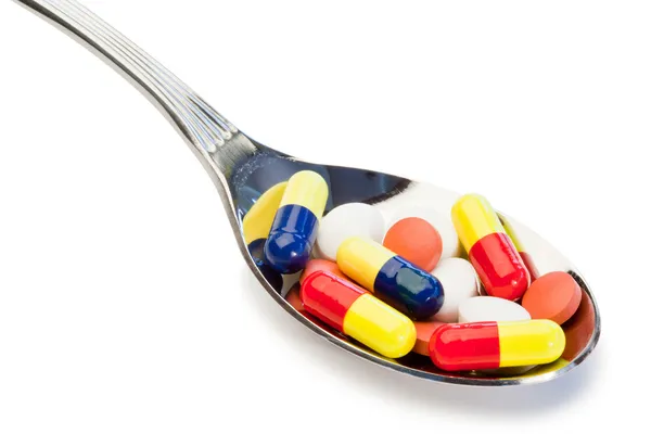 Lepel vol met verschillende soort pillen — Stockfoto