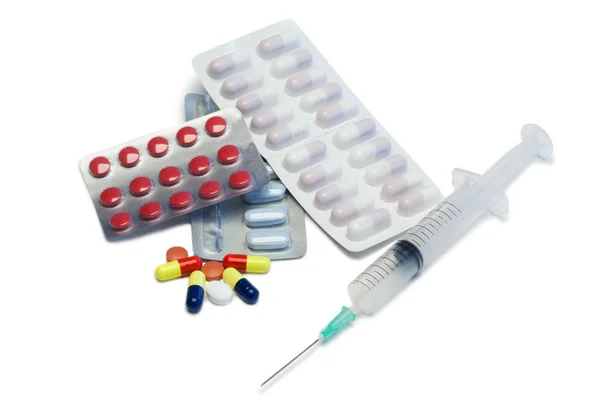 Pills with blister strips and serynge — Stock Photo, Image