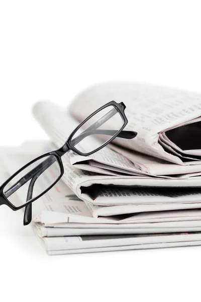 Newspapers and black glasses — Stock Photo, Image