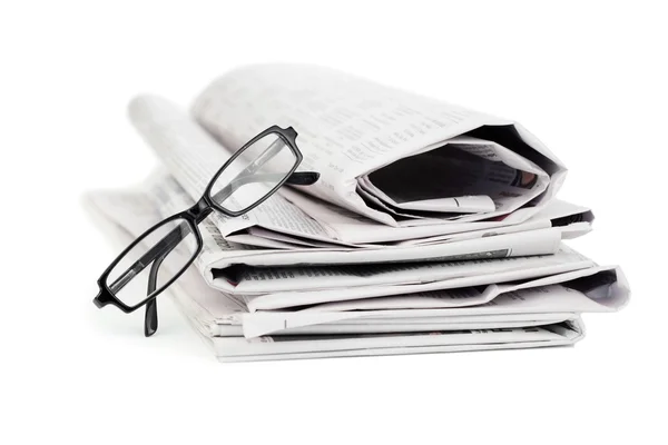 Newspapers and black glasses — Stock Photo, Image
