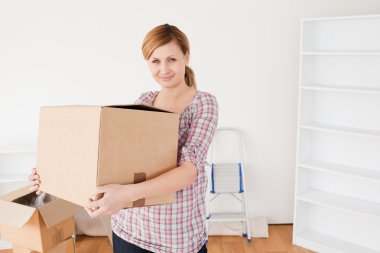 Attractive woman carrying cardboard boxes clipart