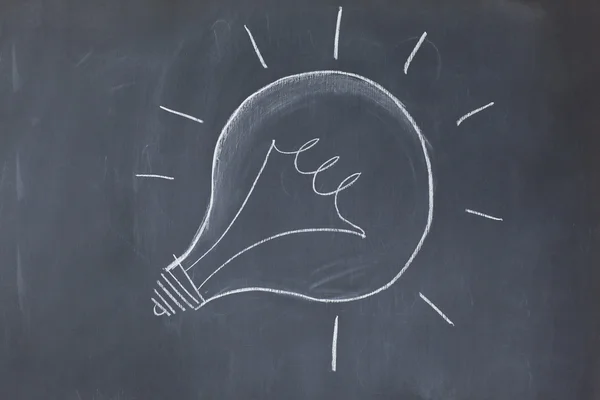 Lightbulb drawn on a blackboard symbolizing ideas — Stock Photo, Image