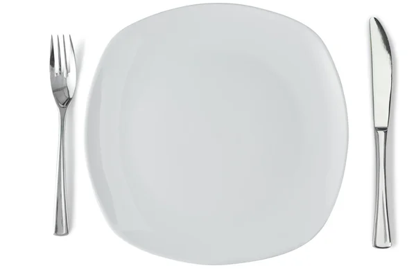 Placa blanca con tenedor y cuchillo de plata — Foto de Stock