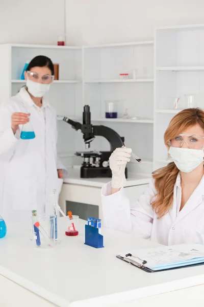Scientists wearing safety glasses and masks — Stock Photo, Image