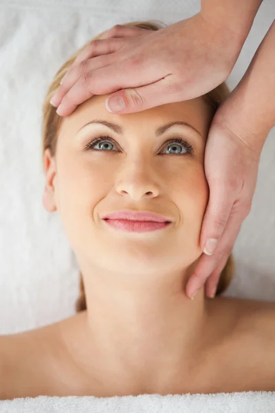 Pretty blond-haired woman getting a massage on her face — Stock Photo, Image