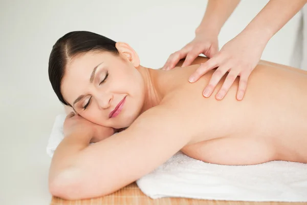 Morena recibiendo un masaje mientras se acuesta — Foto de Stock