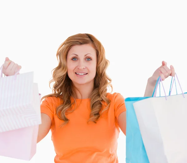 Attractive blond-haired woman showing her shopping — Stock Photo, Image