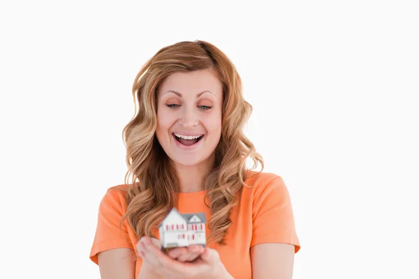 Happy woman holding an house model — Stock Photo, Image
