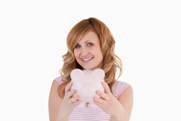 Cute woman posing while holding her piggybank — Stock Photo, Image