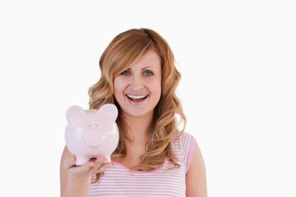 Attractive blond-haired woman posing while holding her piggybank — Stock Photo, Image