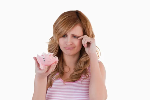 Blond-haired woman crying while holding her broken piggybank — Stock Photo, Image