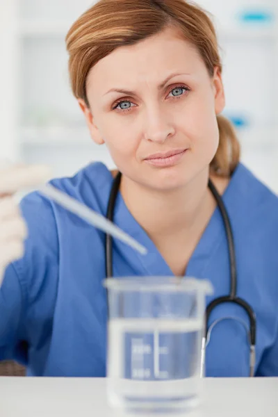 Female scientist preparing an experiment with a pipette and a be — Stock Photo, Image