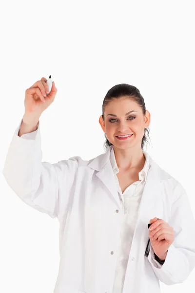 Smiling scientist writing on an empty white board Stock Image