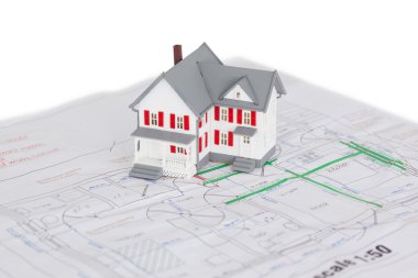 Toy house model on a plan clipart