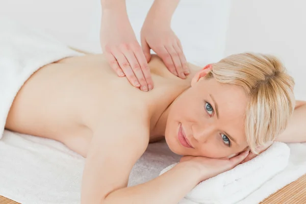 Closeup of young cute blonde woman receiving a back massage in a — Stock Photo, Image