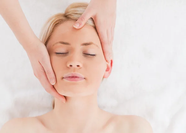 Мила молода жінка отримує масаж на обличчі — стокове фото