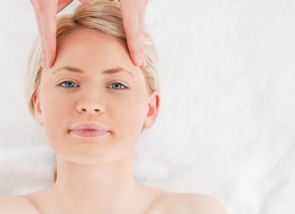 Söt blond kvinna får en massage på hennes ansikte — Stockfoto