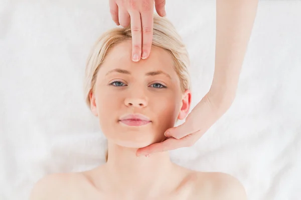 Cute blond-haired woman getting a massage on her face — Stock Photo, Image