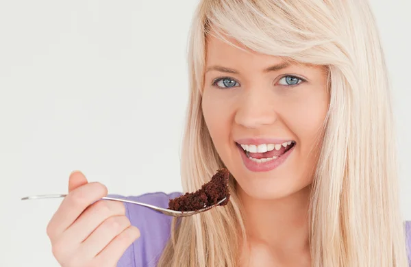 Portret van een knappe blonde vrouw eten taart — Stockfoto
