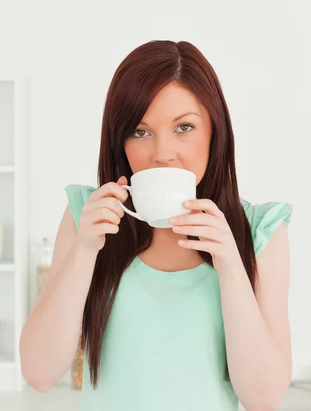 Good looking red-haired woman having her breakfast in the kitche — Stock Photo, Image