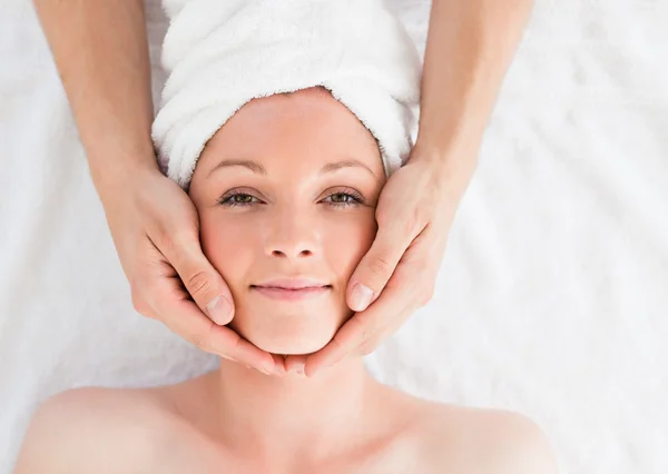 Closeup of a pretty red-haired woman receiving a massage in a sp — Stock Photo, Image