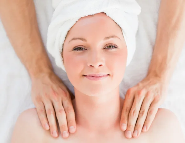 Closeup of a cute red-haired woman receiving a massage in a spa — Stock Photo, Image