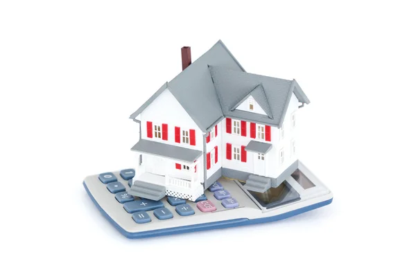 Miniature house with a calculator — Stock Photo, Image