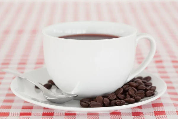 Coffee and beans on a tablecloth — Stock Photo, Image