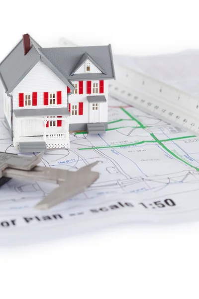 Close-up of toy house model and ruler on a plan — Stock Photo, Image