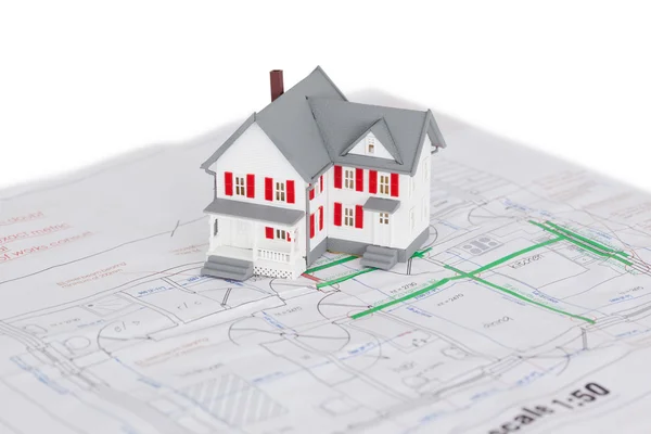 Toy house model on a plan — Stock Photo, Image