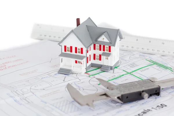 Close-up of toy house model and caliper on a plan — Stock Photo, Image