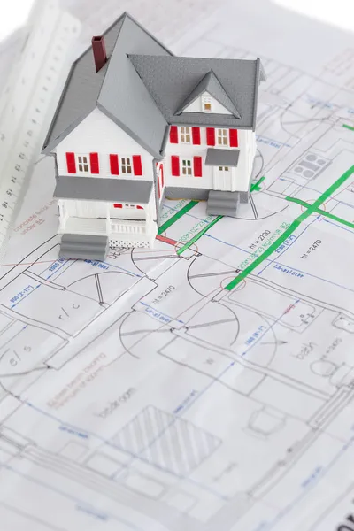 Close-up of toy house model and ruler on a plan — Stock Photo, Image