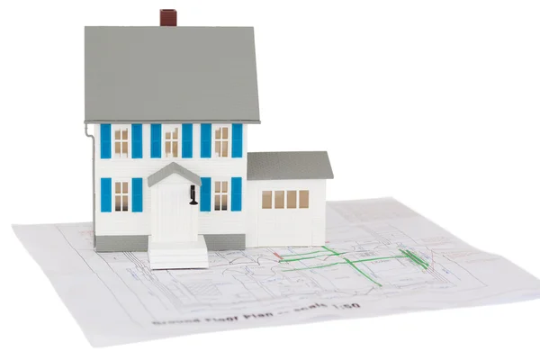 Closeup of a toy house model on a ground floor plan — Stock Photo, Image
