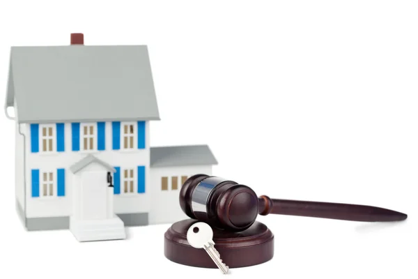 Stock image Grey toy house model with a key and a brown gave