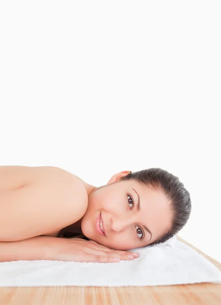 Smilling young woman on a towel — Stock Photo, Image