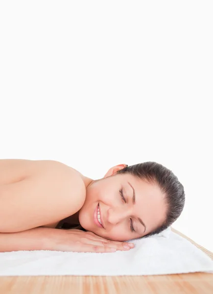 Young woman on a towel eyes closed — Stock Photo, Image