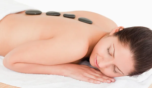 Young woman with black stones on her back — Stock Photo, Image