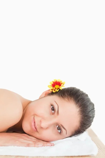Brunette with flower on her ear — Stock Photo, Image