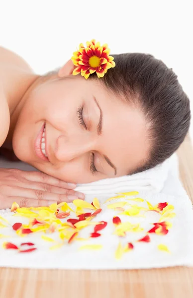Brunette and flowers petals in a spa — Stock Photo, Image