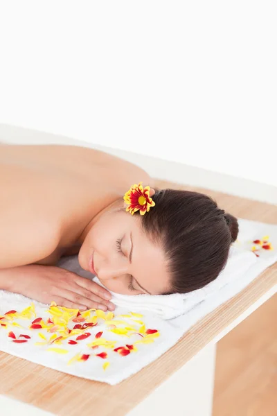 stock image Cute woman closing her eyes while surrounded by flowers