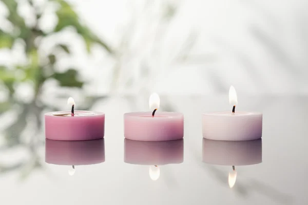 stock image Lighted candles on a mirror